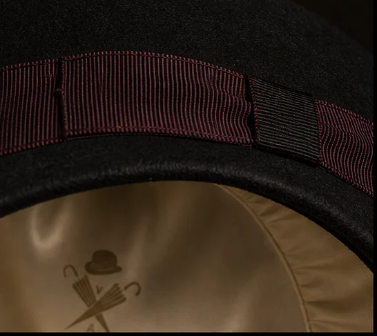 Close view of the felt, oxblood ribbon and Steeple lining